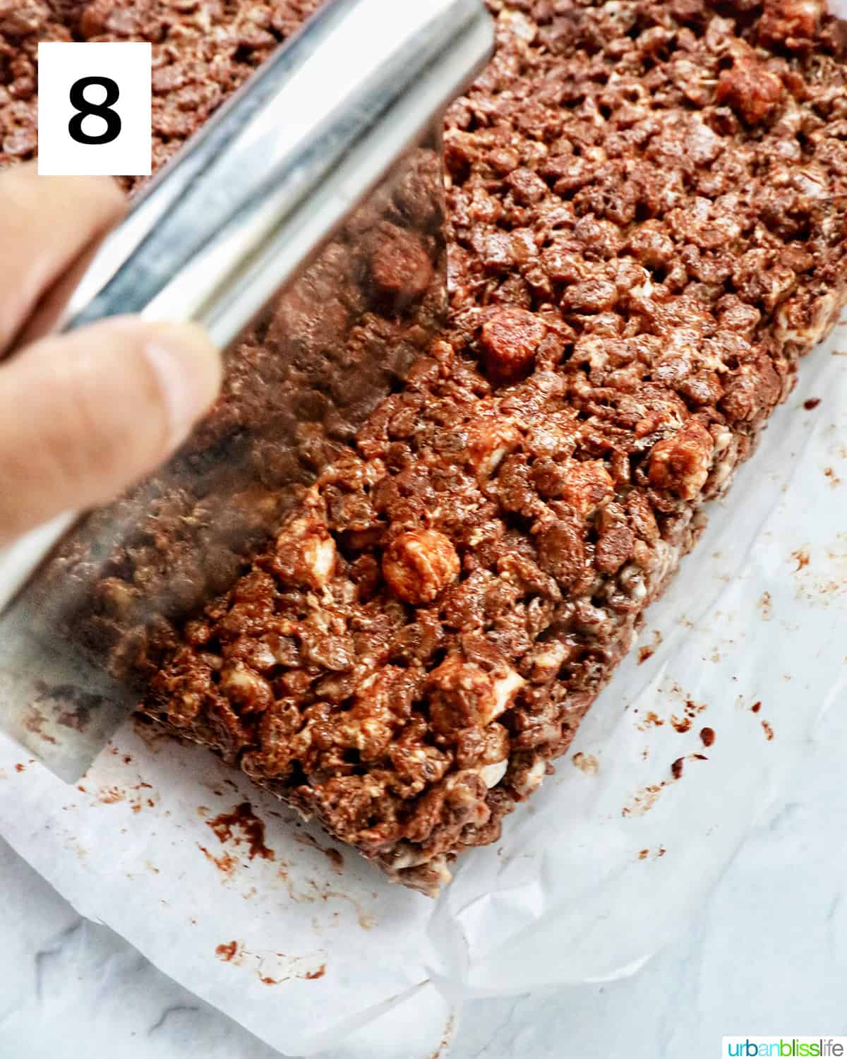 slicing chocolate rice krispies treats