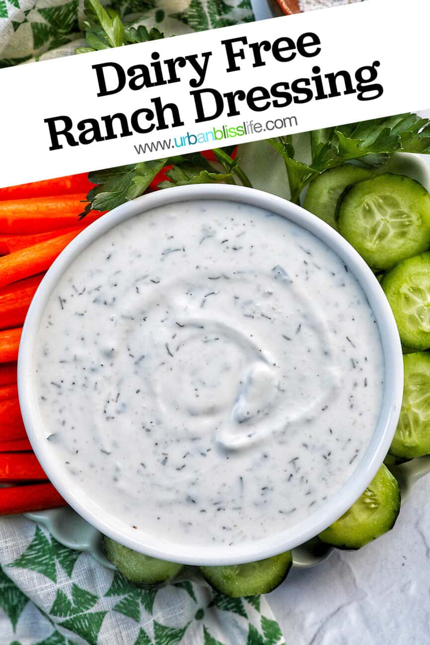 bowl of dairy free ranch dressing with carrot sticks, cucumber slices, and herbs with title text overlay.