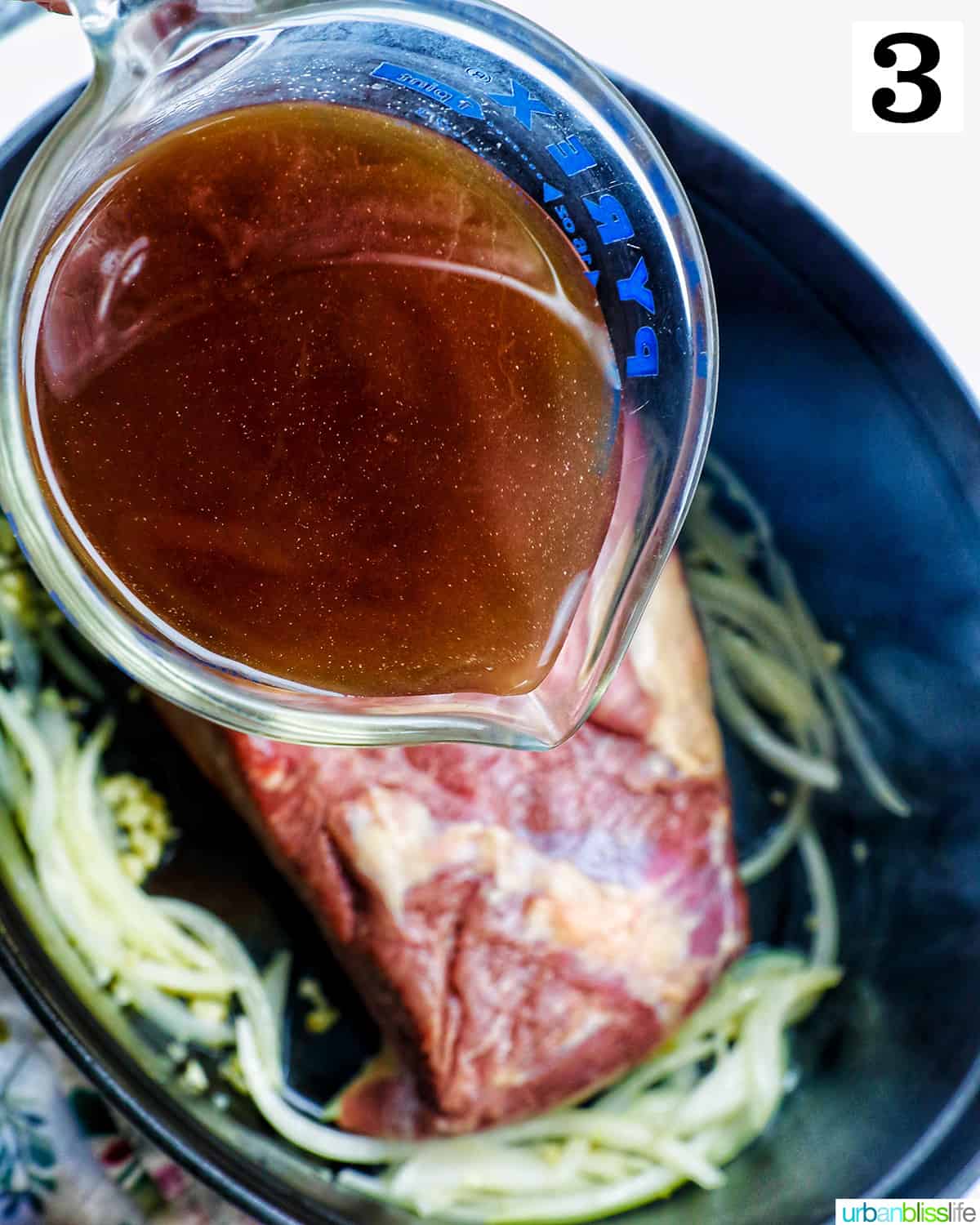 pouring beef broth into a dutch oven with beef brisket.