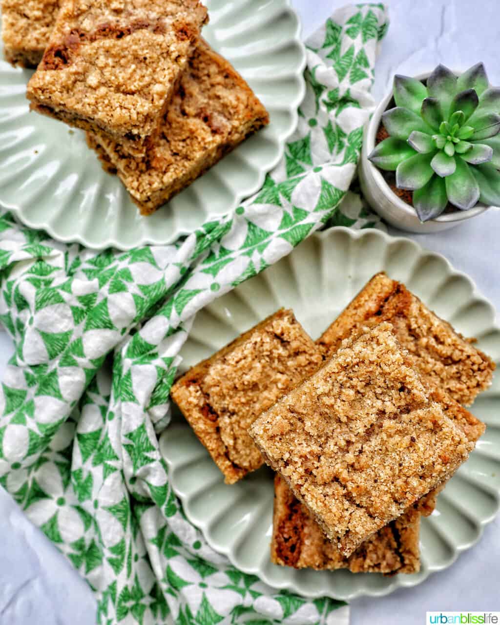 two stacks of Irish coffee cake on green plates with green patterned napkins and a green plant.