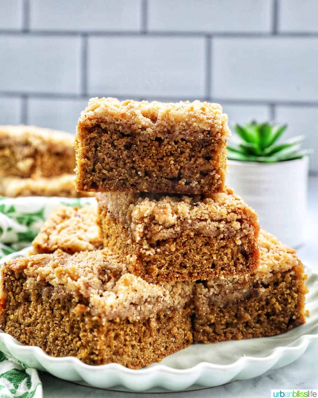 stack of Irish coffee cake on a green plate with green patterned napkins.