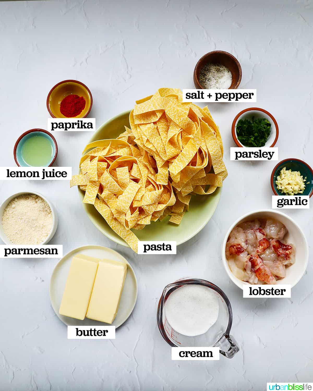 bowls of individual ingredients to make lobster pasta.