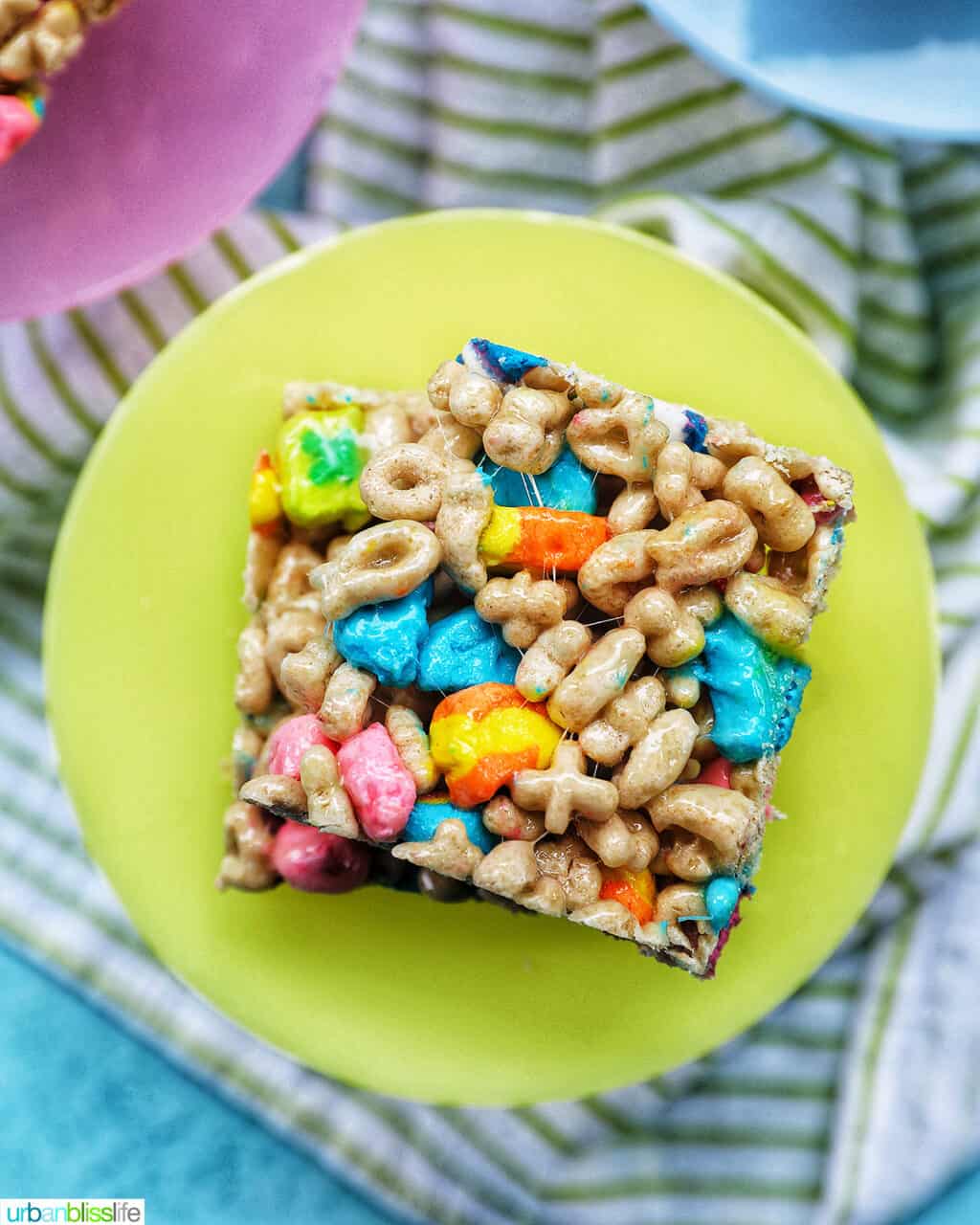 overhead photo of stacked lucky charms cereal bars on a green plate.
