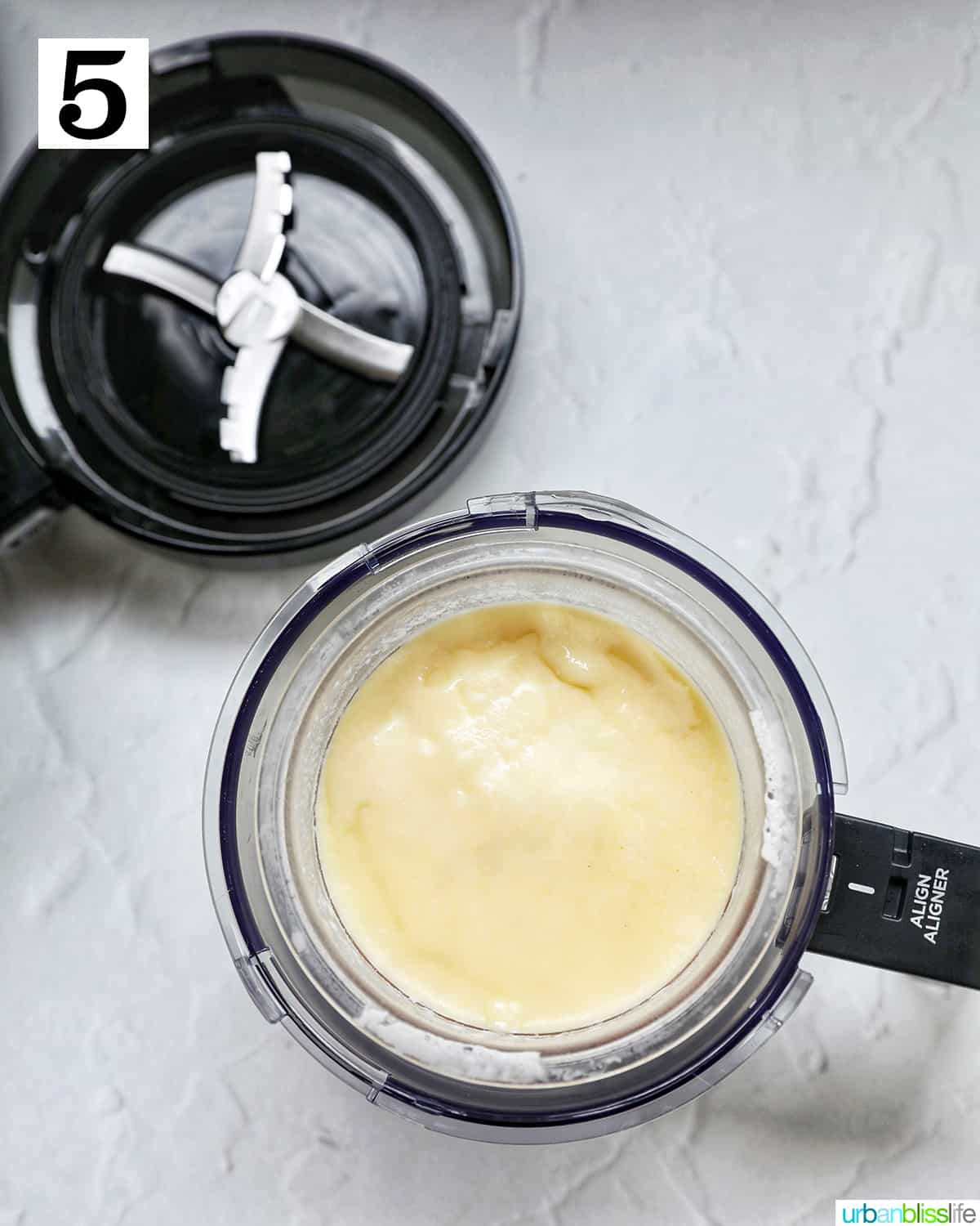 Frozen Stracciatella ice cream mixture in a Ninja Creami pint container in the Creami bowl.