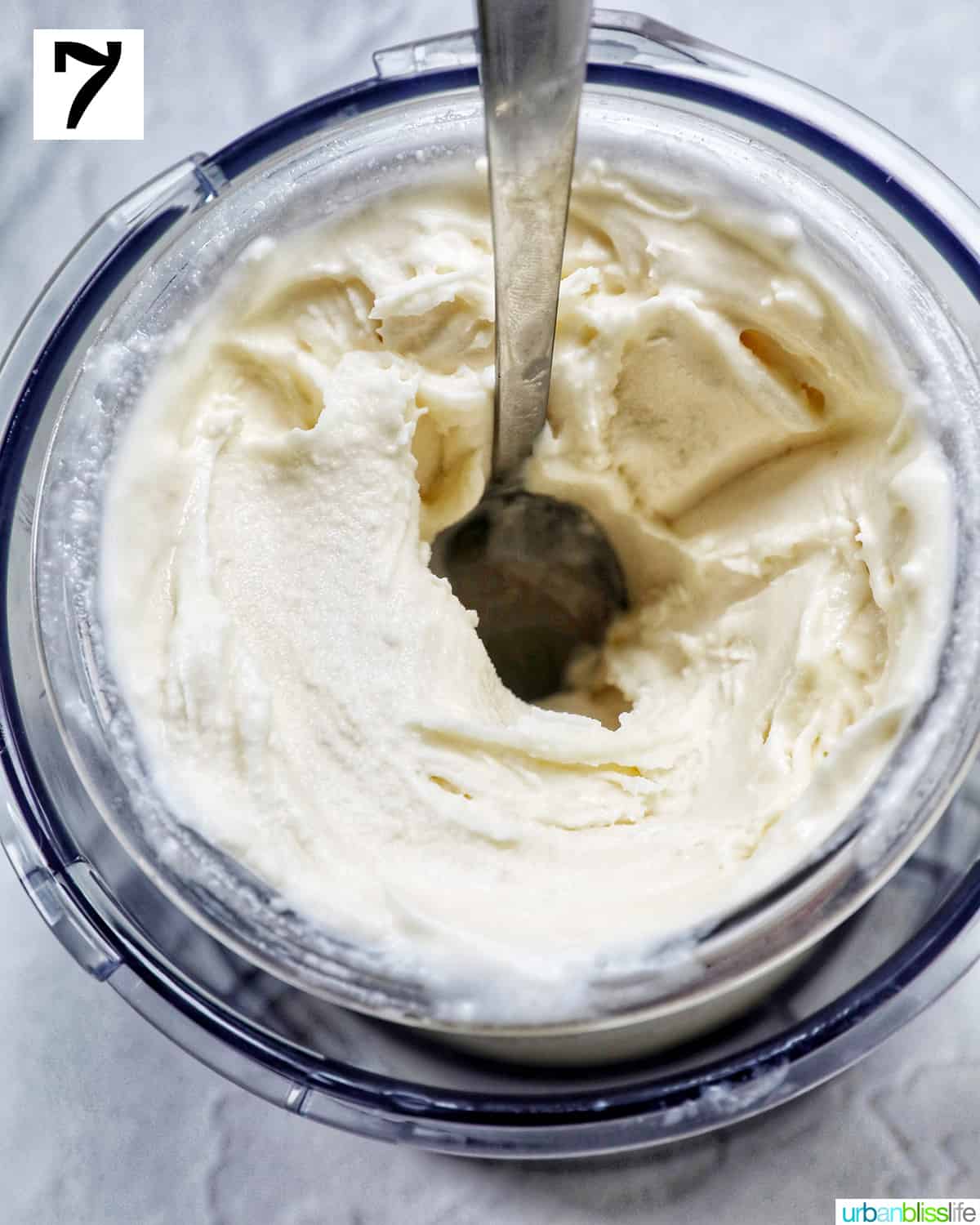 Ninja Creami pint container with stracciatella ice cream and a spoon making a hole.
