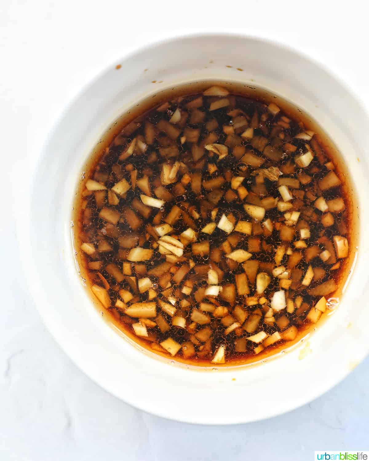white bowl with teriyaki sauce.