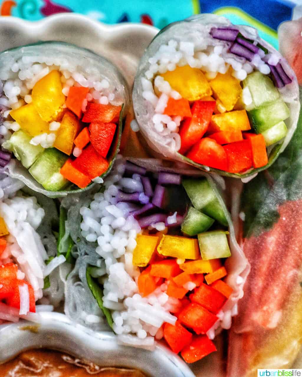 vegan summer rolls cut in half showing the vegetables and vermicelli noodles