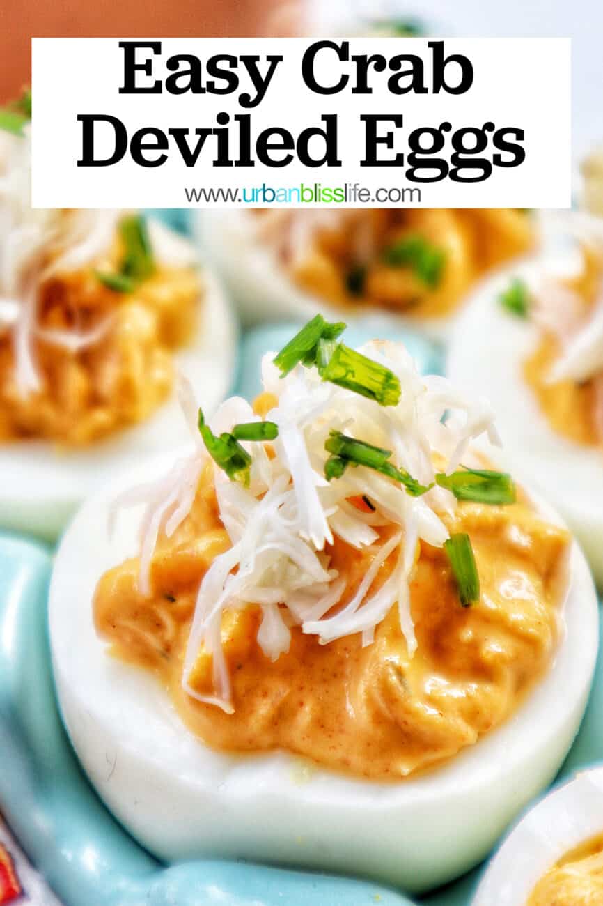 close-up of crab deviled eggs in a blue egg holder with title text that reads Crab Deviled Eggs.