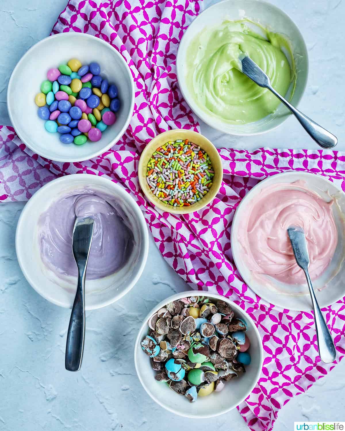 bowls of pastel colored chocolate and candies.