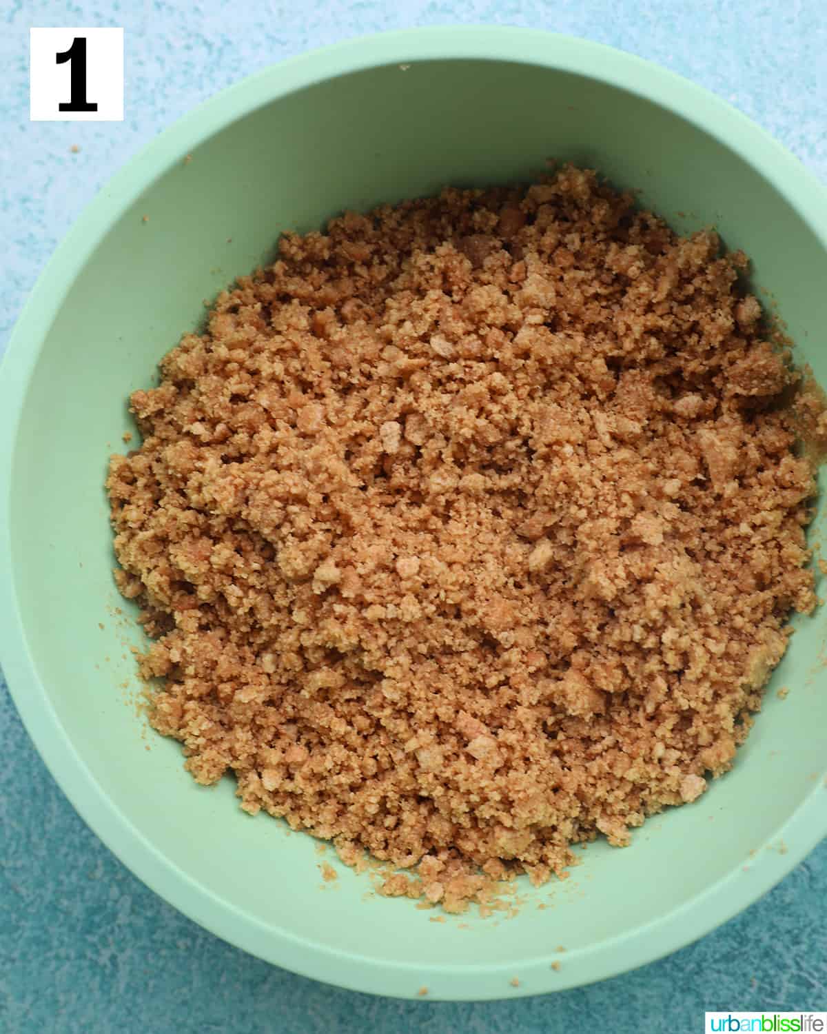 cookie crust crumbled in a green bowl.