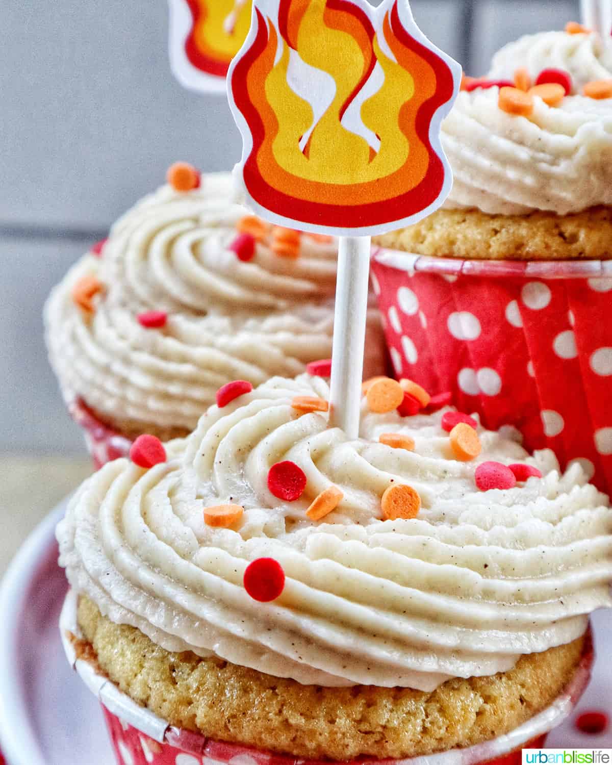 closeup of fireball cupcakes with sprinkles and a fire cupcake stick.