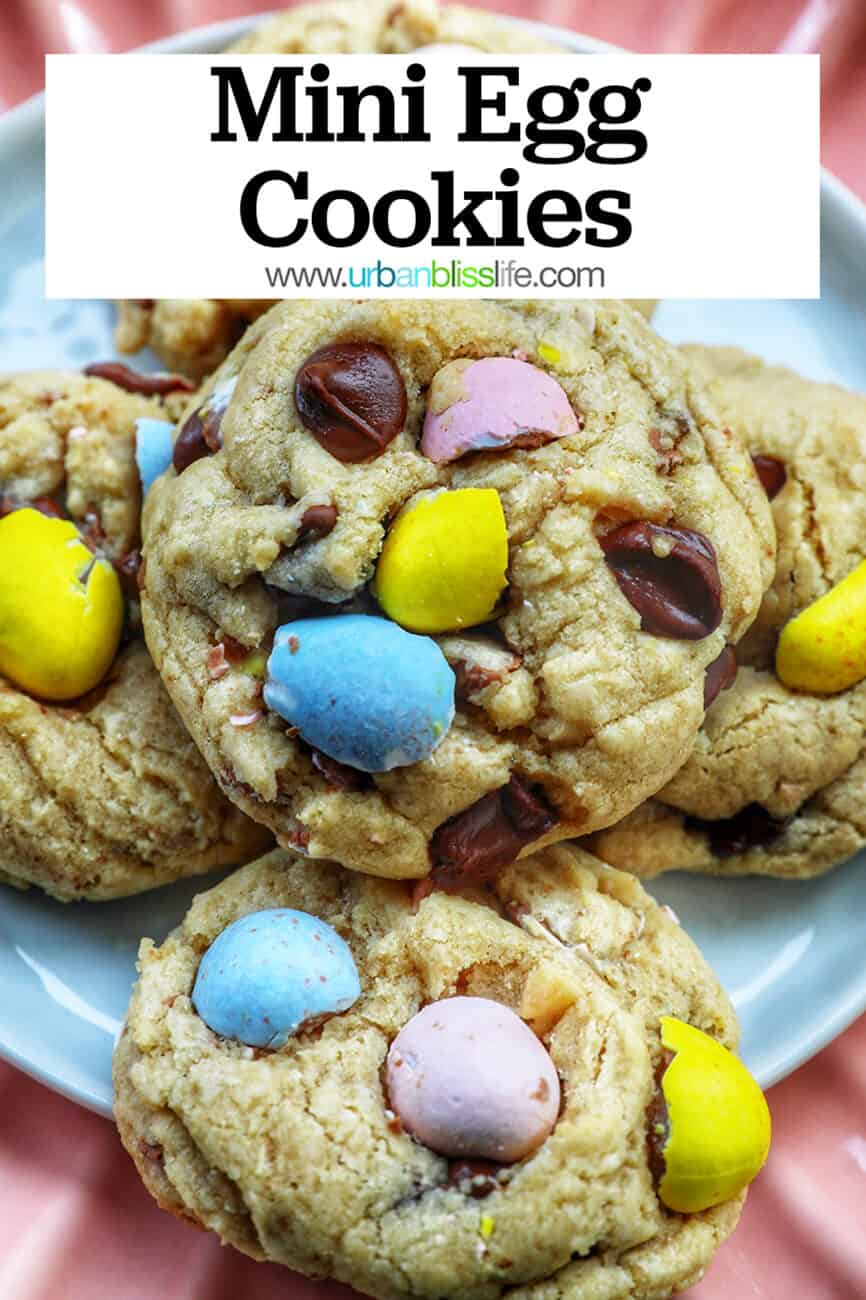 stack of Easter mini egg cookies on a pink scalloped plate with text that reads Mini Egg Cookies.