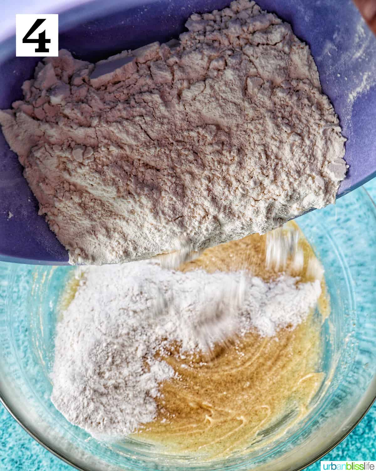 adding dry ingredients to wet ingredients in cookie batter.