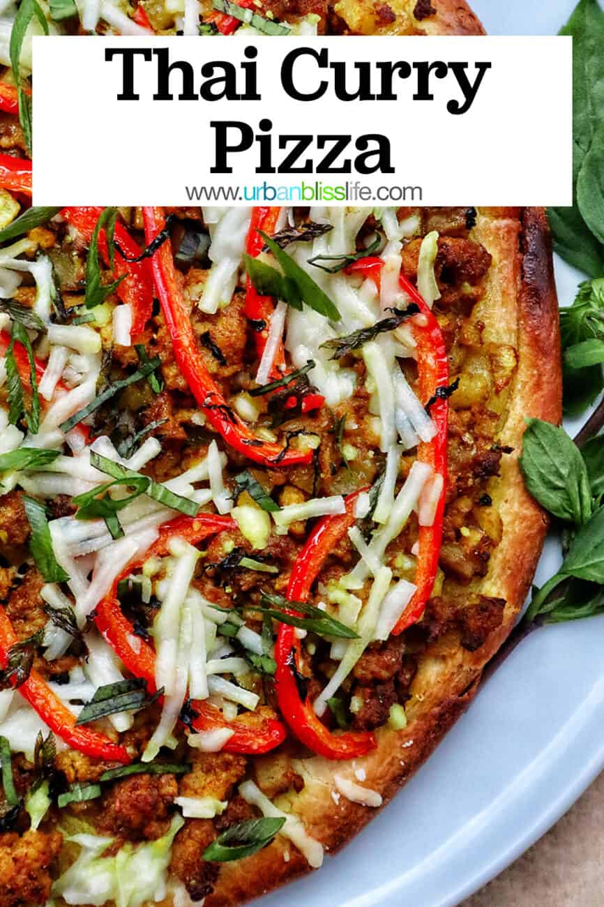 closeup of thai curry pizza toppings with sliced red peppers and sliced fresh basil.