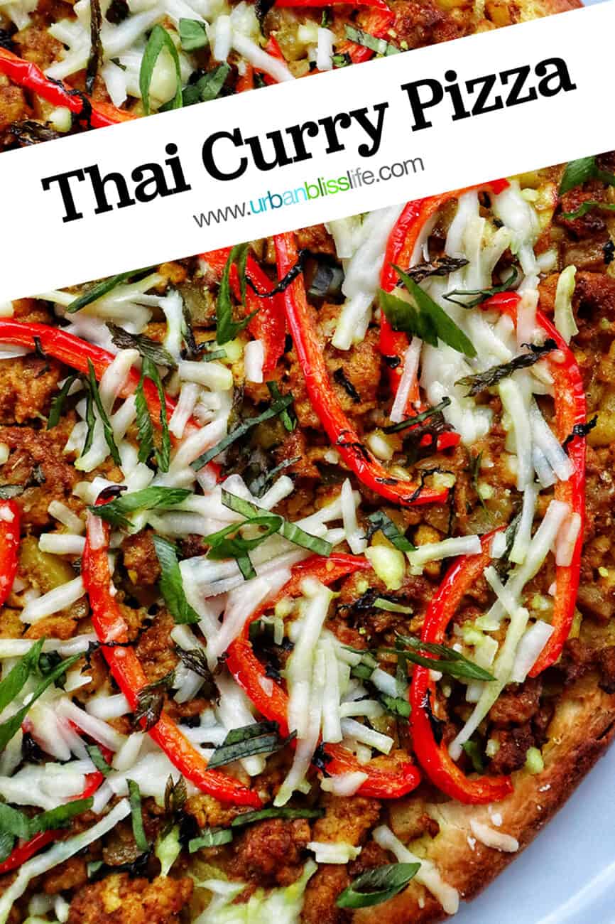 closeup of thai curry pizza toppings with sliced red peppers and sliced fresh basil.
