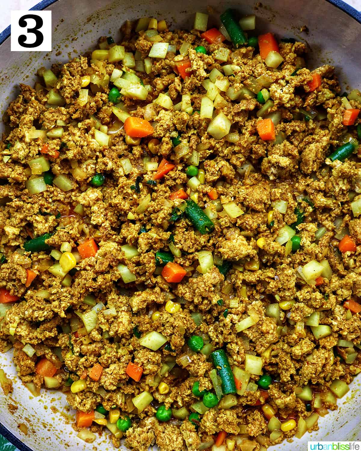 cooked ground chicken, mixed veggies, potatoes for Thai curry puff filling in a skillet.
