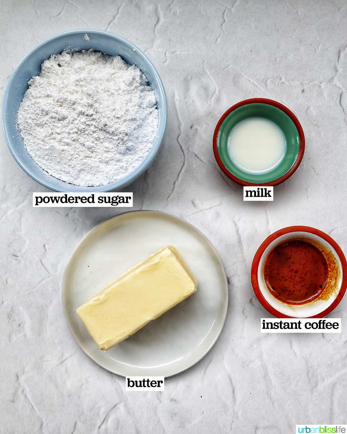 bowls of ingredients to make coffee buttercream frosting.