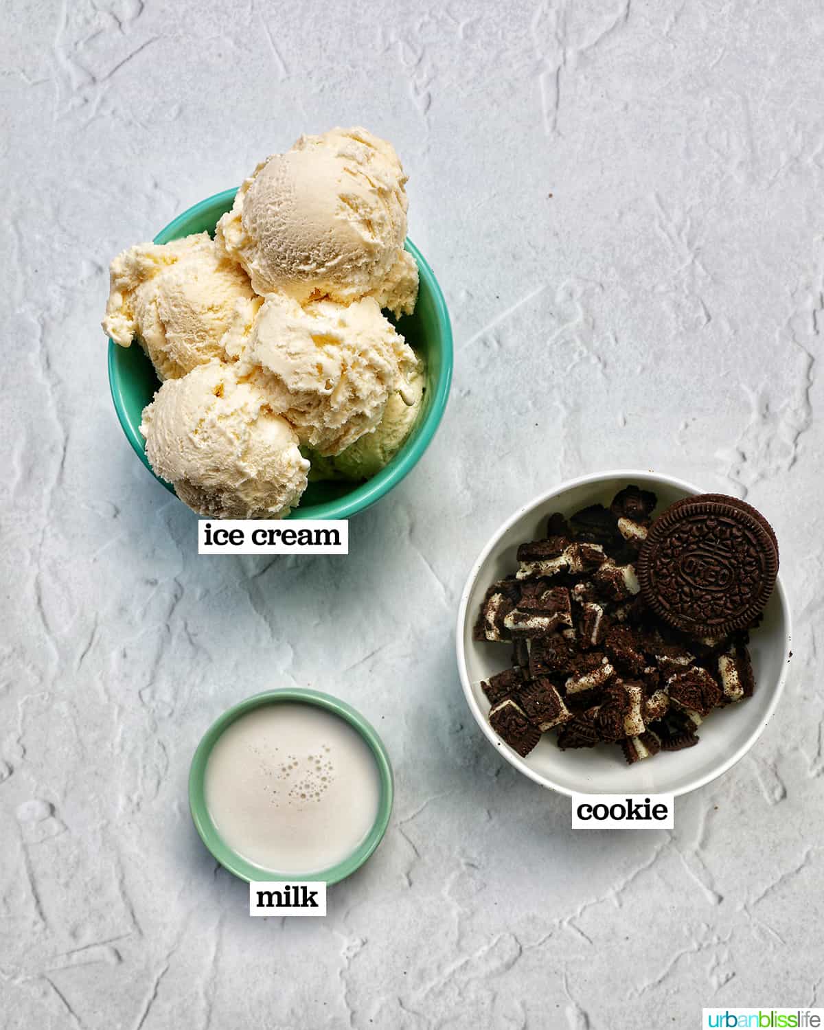 three bowls of ingredients to make cookies and cream milkshakes.
