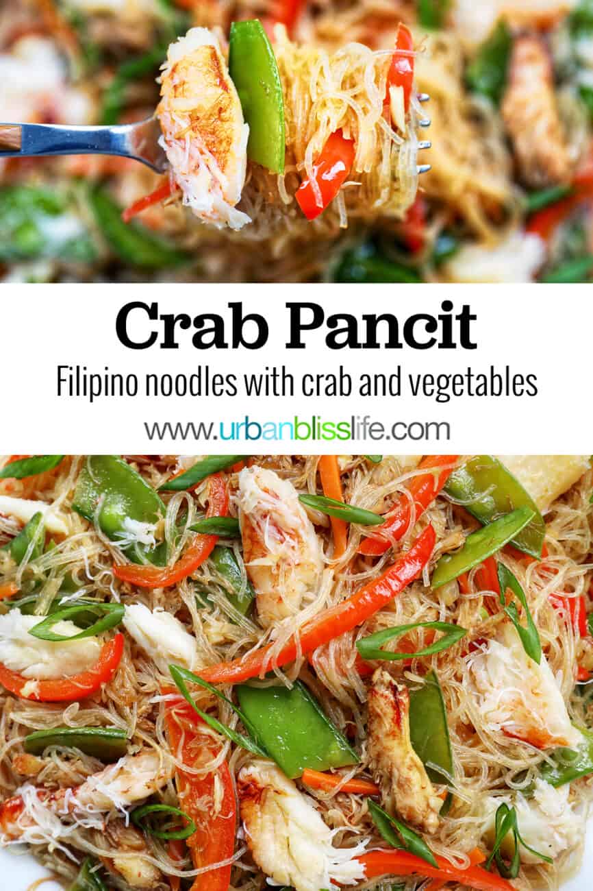 crab pancit filipino noodles in a large bowl, with slices veggies and chunks of crab meat.