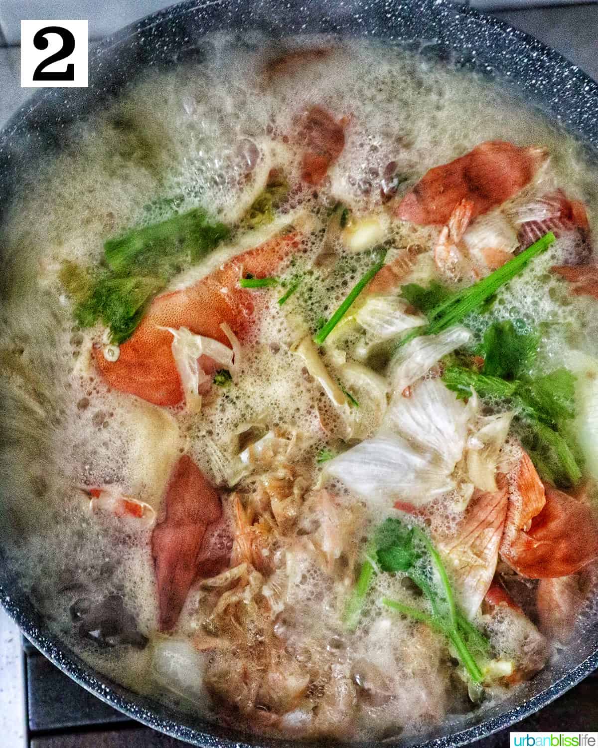 large stockpot with crab stock cooking in it.