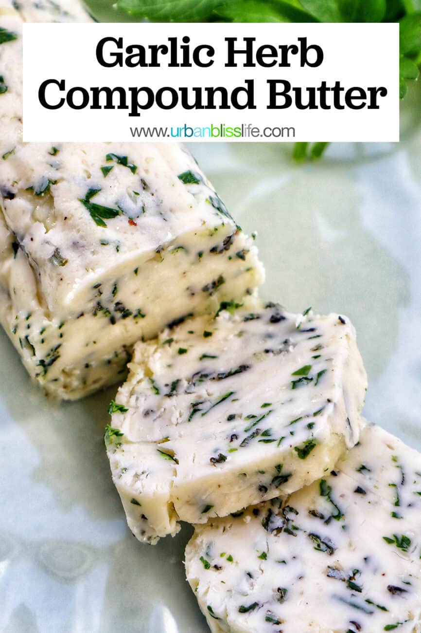 garlic herb compound butter on a green plate with side of herbs.