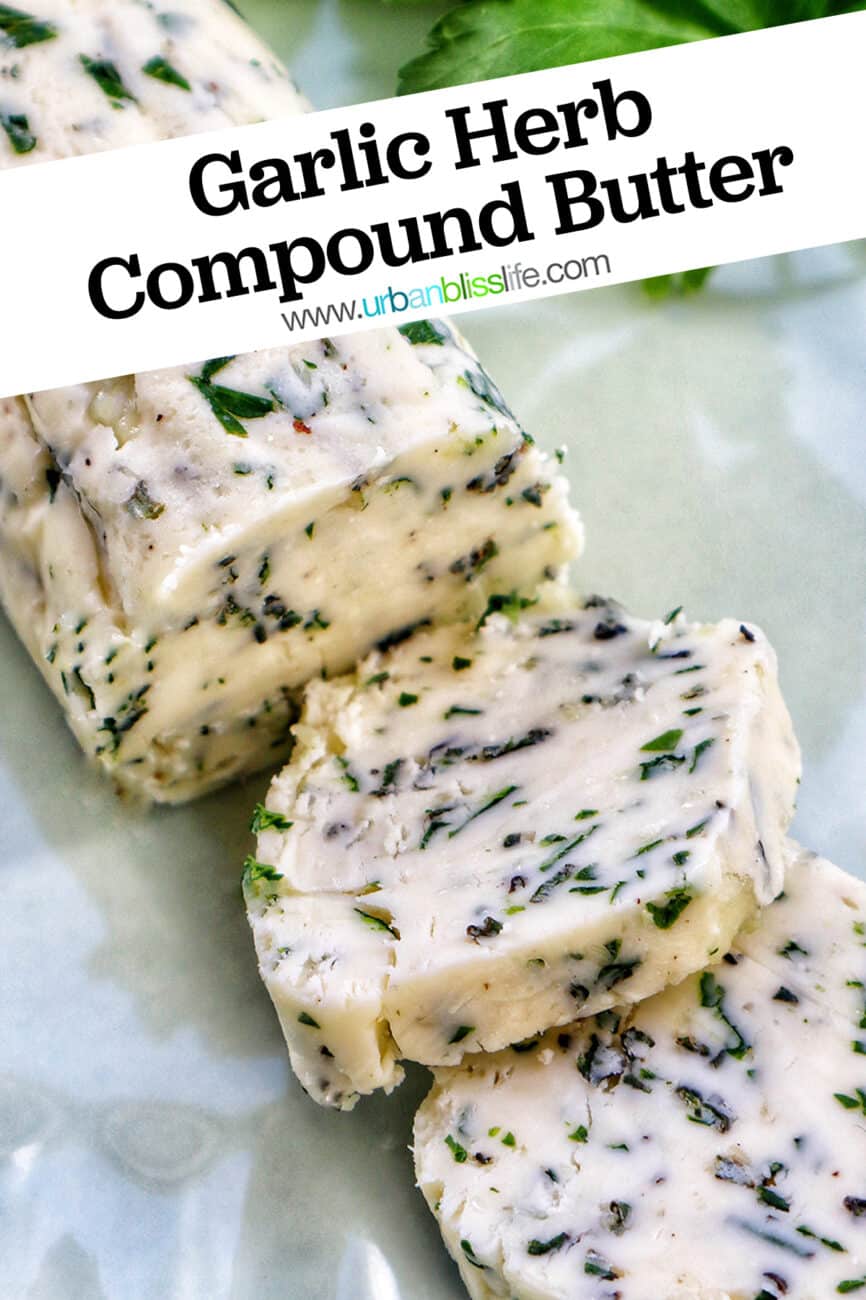 garlic herb compound butter on a green plate with side of herbs.