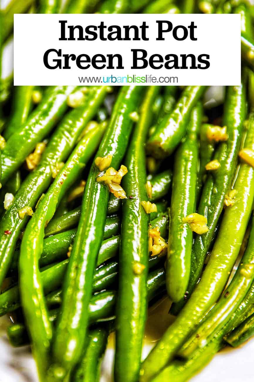 close up of green beans with garlic in a white bowl.