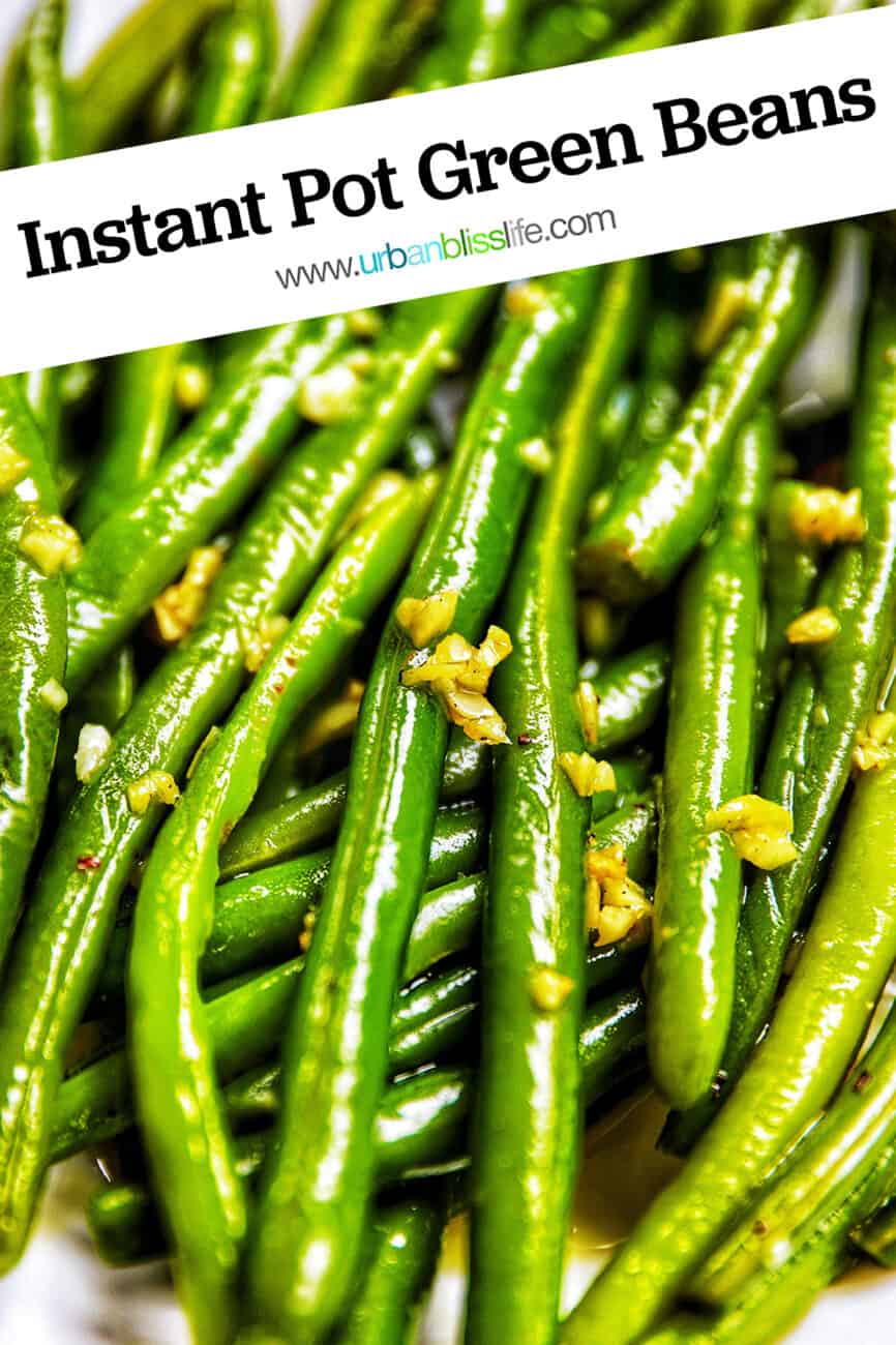 close up of green beans with garlic in a white bowl.