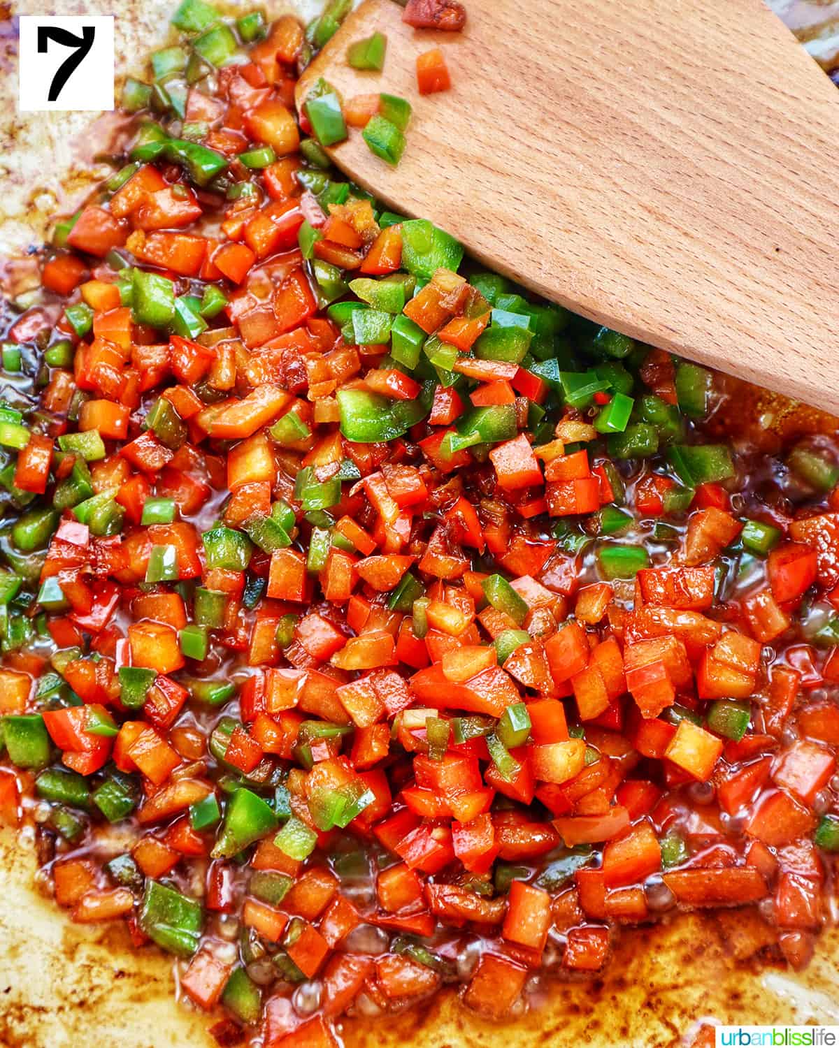 cooking red and green bell peppers in a pan.