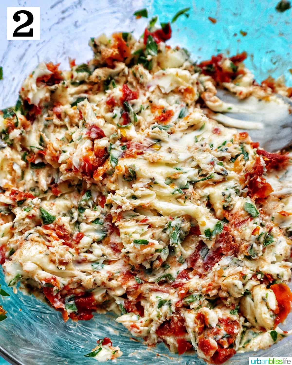 ingredients to make sun-dried tomato butter in a bowl mashed together.
