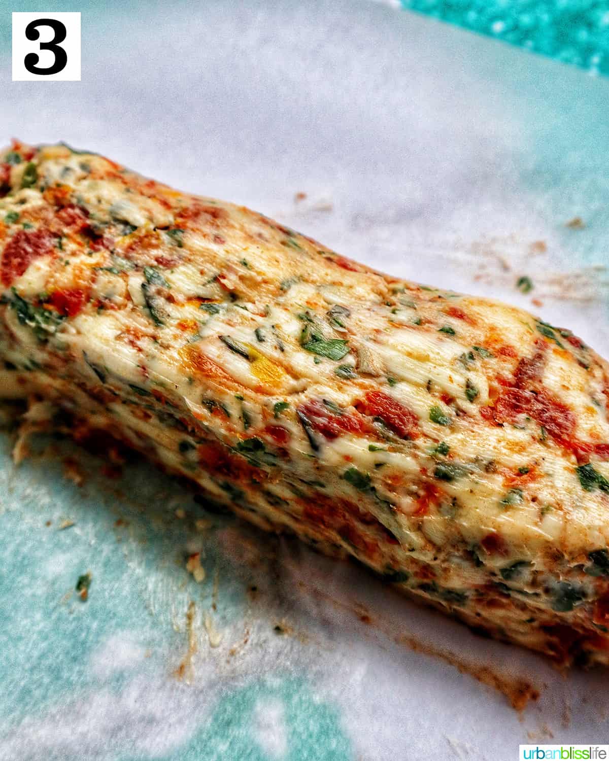 sun dried tomato compound butter log on parchment paper.