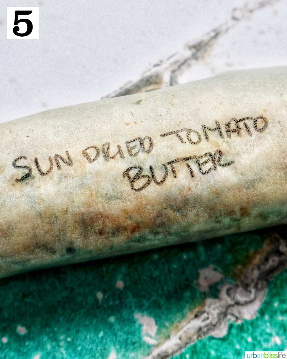 sun dried tomato butter wrapped in parchment paper and labeled.