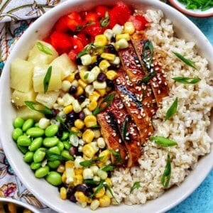 chicken teriyaki donburi bowl with brown rice, teriyaki chicken, corn, edamame, pineapple, red pepper.