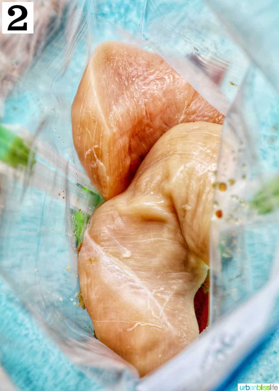 three chicken breasts in a ziplock bag with teriyaki marinade.