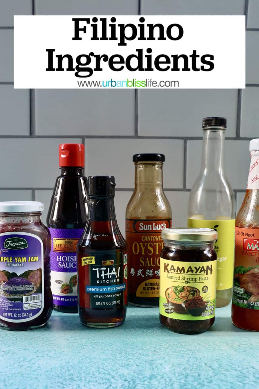 several jars and bottles of Filipino ingredients used in Filipino cuisine on a blue table with text that reads Filipino Ingredients.