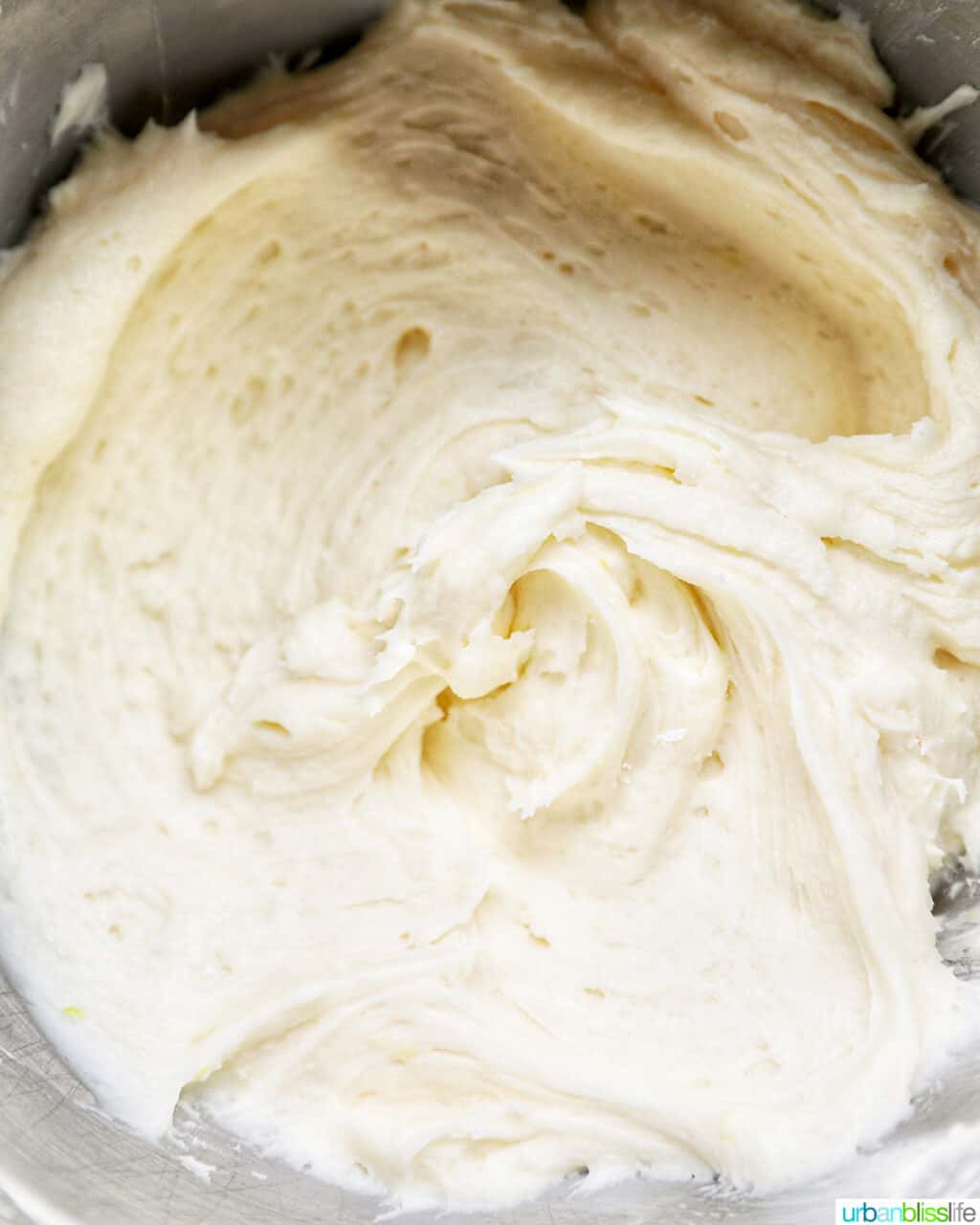 lemon buttercream frosting in the bowl of a stand mixer.