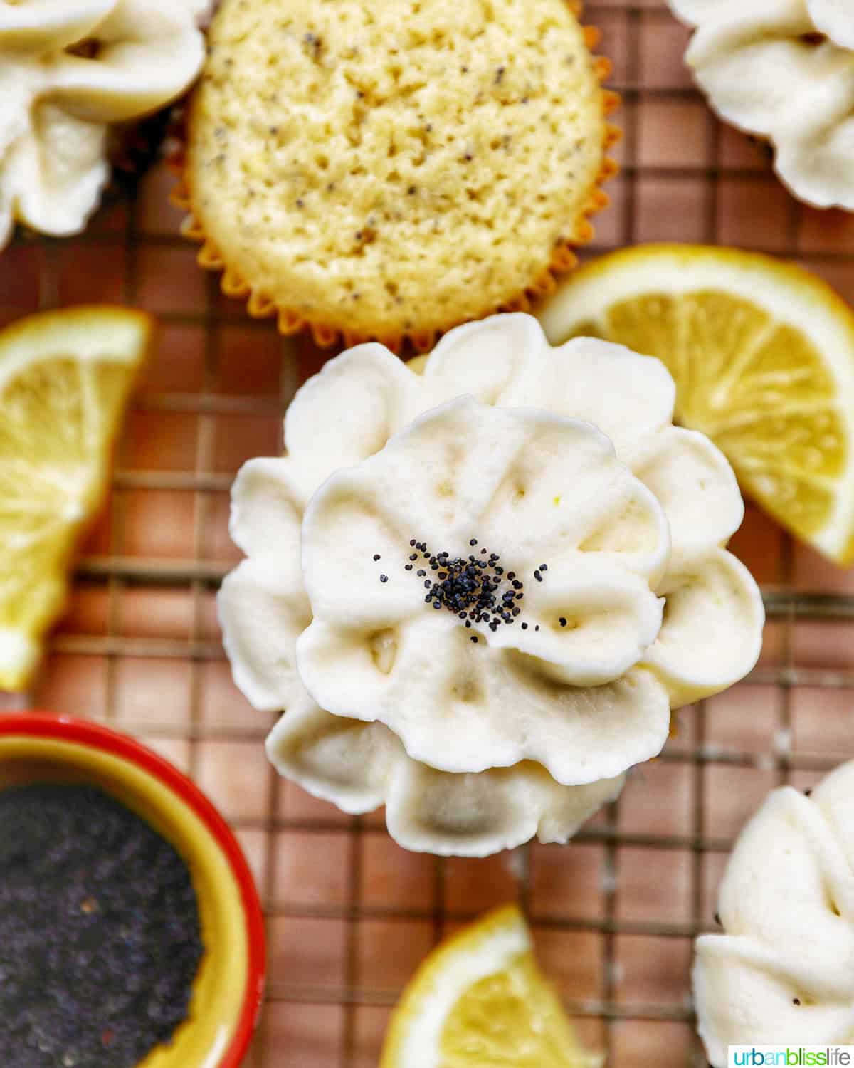 closeup of lemon poppyseed cupcakes decorated in lemon buttercream frosting shaped like a flower.