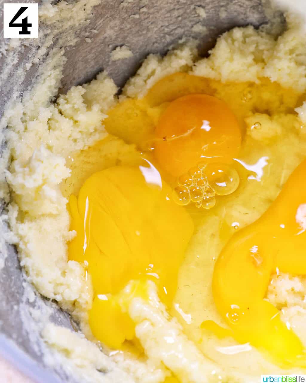 eggs added to cupcake batter in a stand mixer bowl.