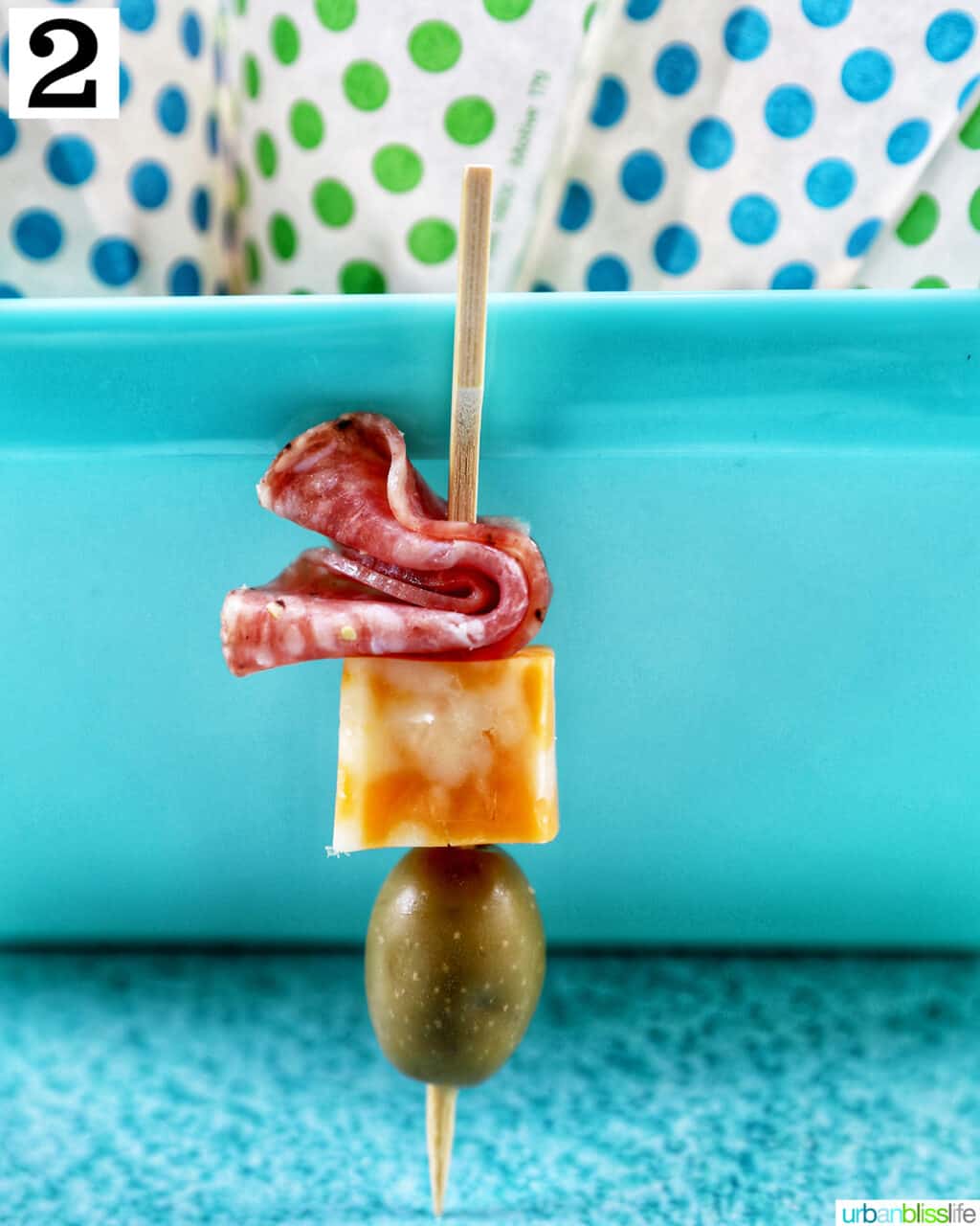 food skewer with salami, cheese, and olives.