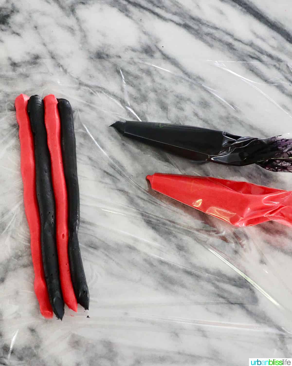 piping red and black frosting to make Darth Vader themed cupcakes.