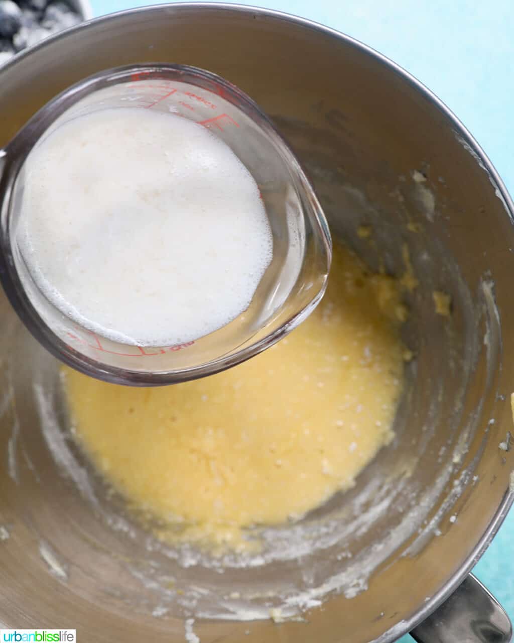 cup of milk over cake batter.