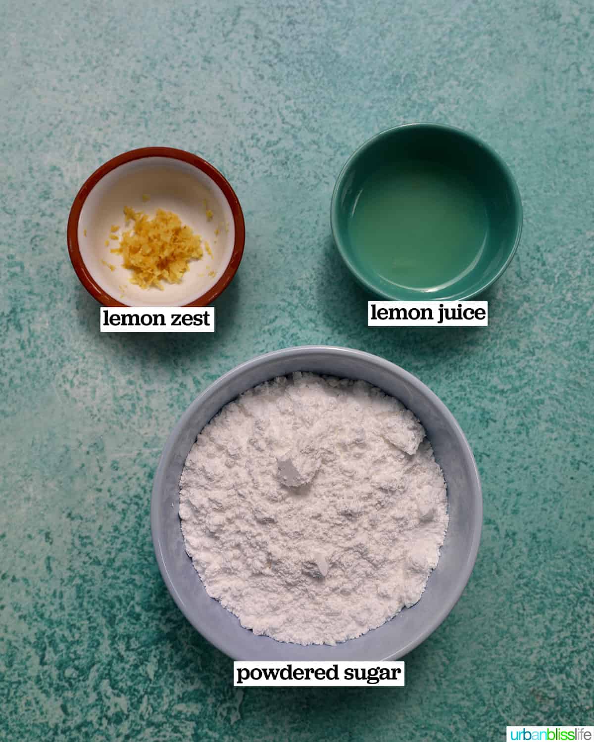 bowls of ingredients to make glazed icing, on a blue background.