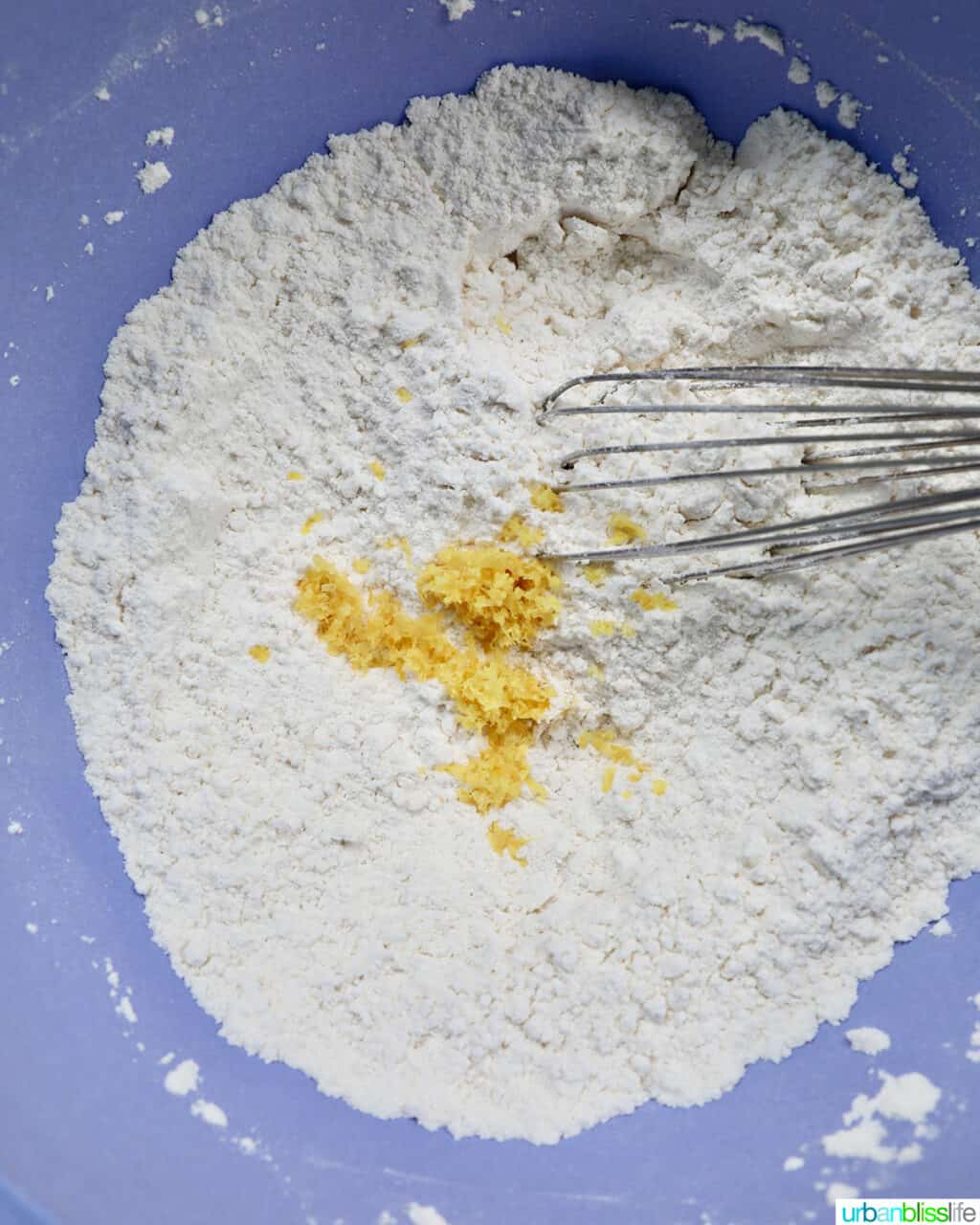 whisk in a bowl with flour and lemon zest.