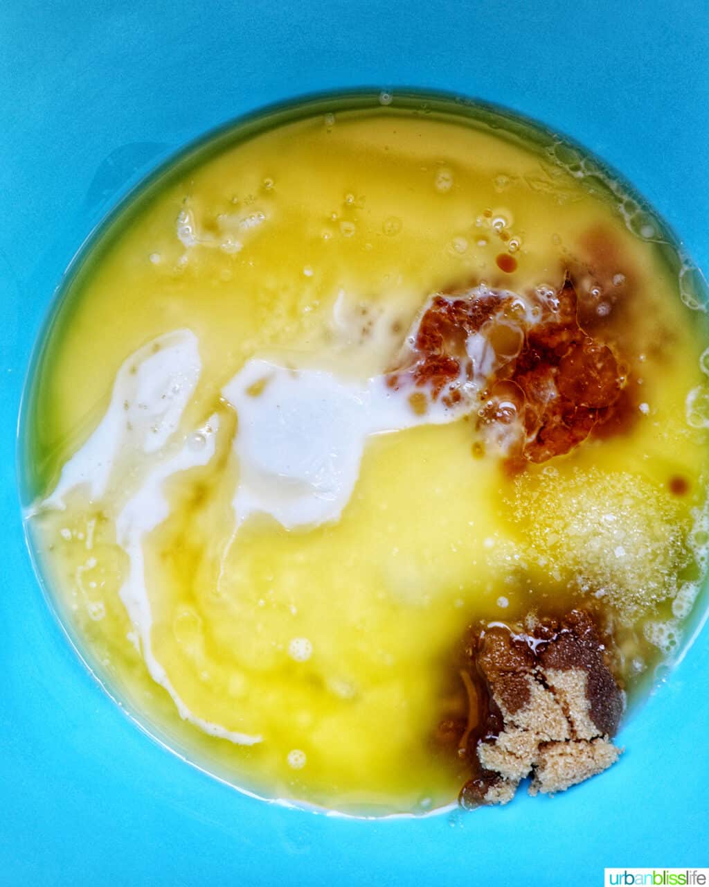 wet baking ingredients in a blue bowl.