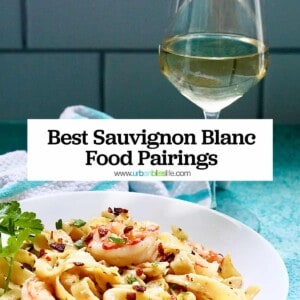 glass of white wine behind a bowl full of shrimp pasta with title text overlay that reads "Best Sauvignon Blanc Food Pairing."