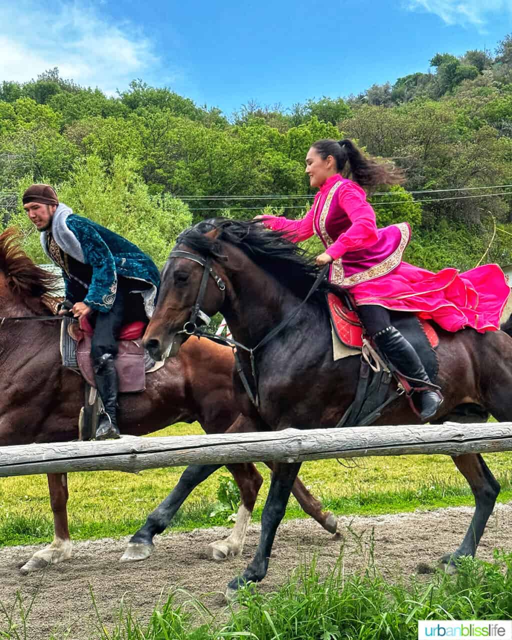 Woman and man on horseback at Ethno Village of the Huns near Almaty, Kazakhstan.