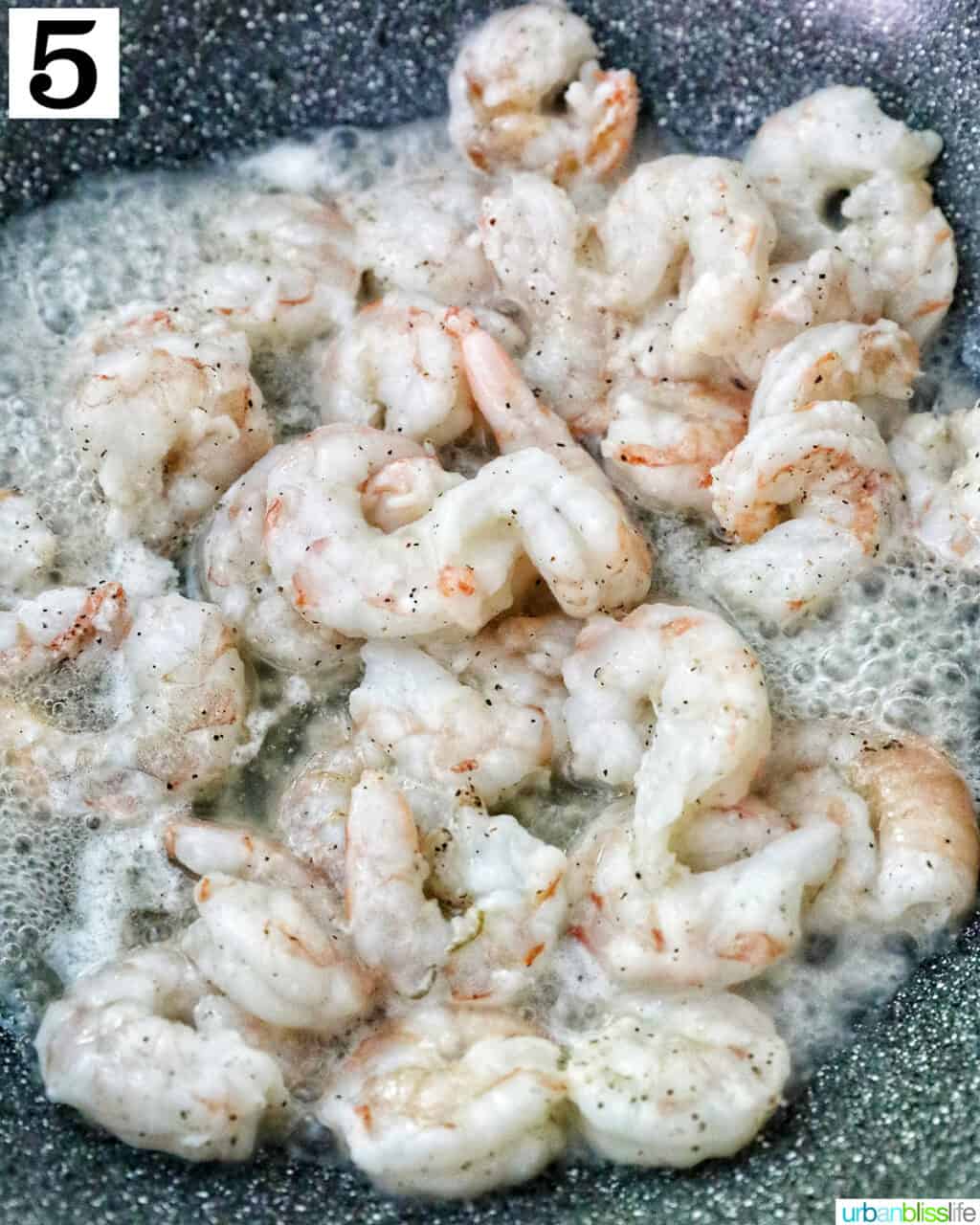 prawns cooking in a wok.