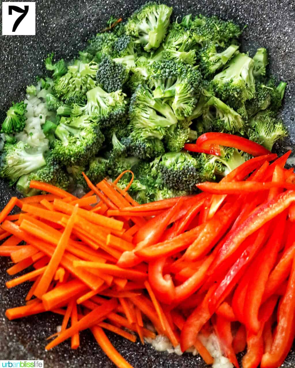 chopped broccoli, carrots, and red peppers in a wok.
