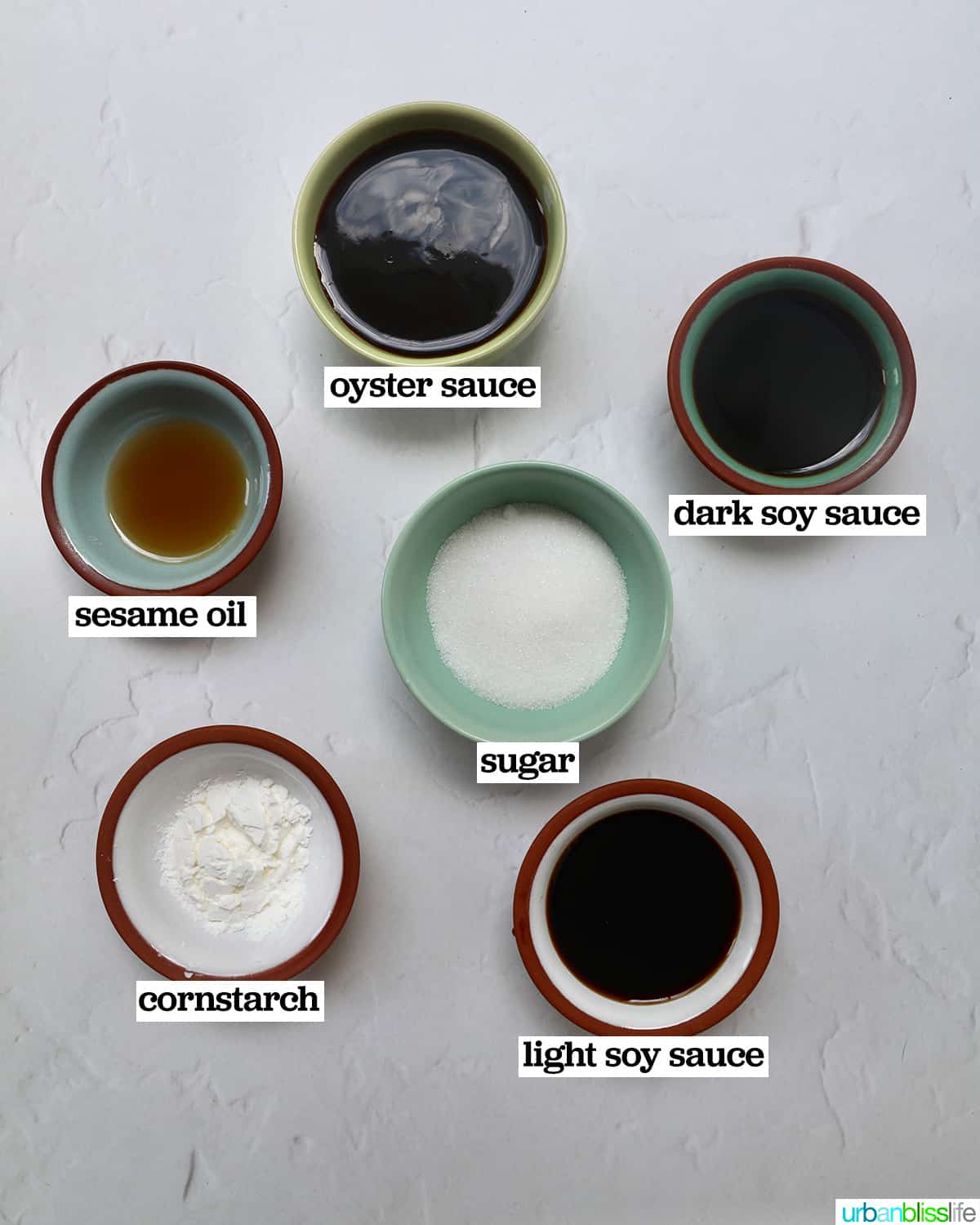bowls of ingredients to make sauce for white bowl of bowl of prawn chow mein noodles.