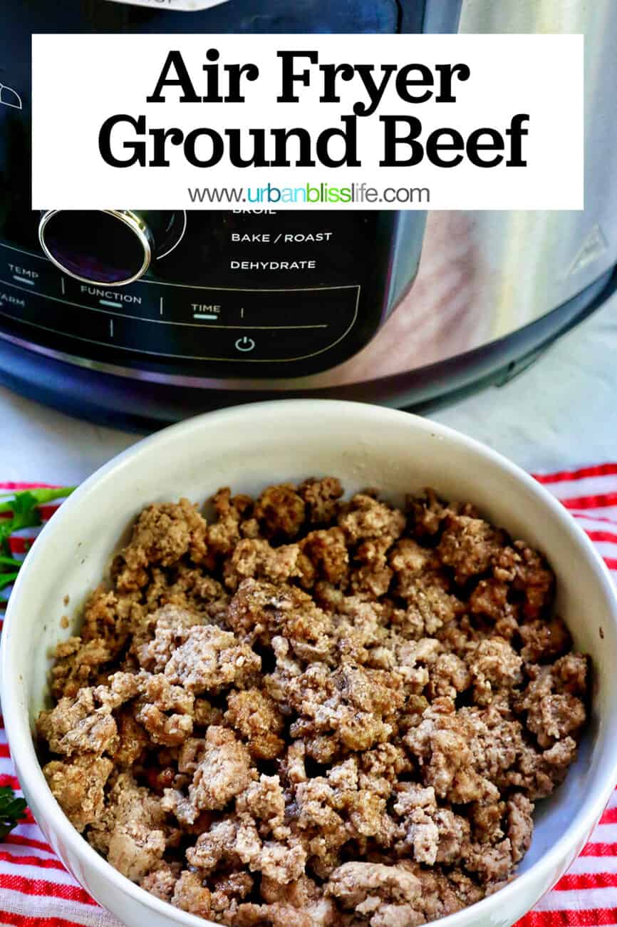 air fryer and ground beef in a white bowl with parsley sprigs around it and a red and white striped towel.